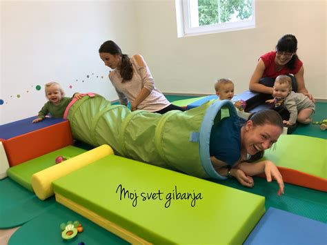 dojenček sedi in se igra z igračo